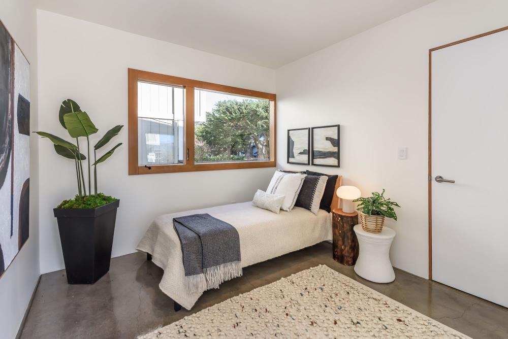 1241 Main Street Montara, CA 94037 - Photo 18 of 34 a bedroom with a bed and a potted plant