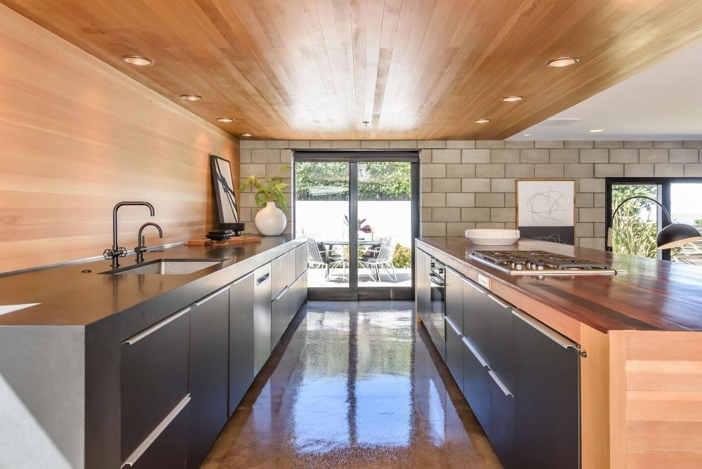 1241 Main Street Montara, CA 94037 - Photo 9 of 34 a kitchen with kitchen island granite countertop a sink appliances counter top and a large window