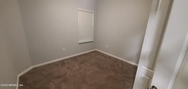 a view of an empty room with windows