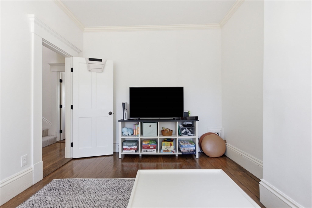 38 Bartlett Street Boston, MA 02129 - Photo 21 of 37 a living room with furniture and a flat screen tv