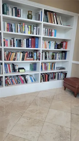 a room with a book shelf and a book shelf