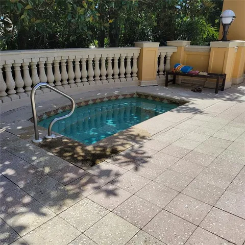 a view of swimming pool with outdoor seating and a forest