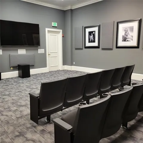 a room with a table chairs and a flat screen tv