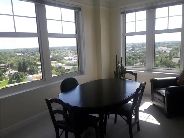 a dining room with furniture and window