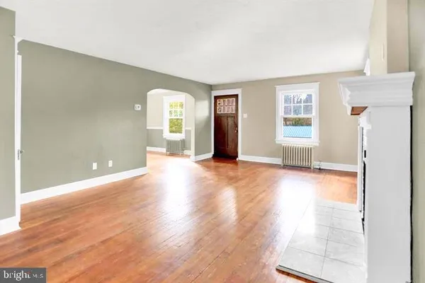a view of a livingroom with wooden floor and a window