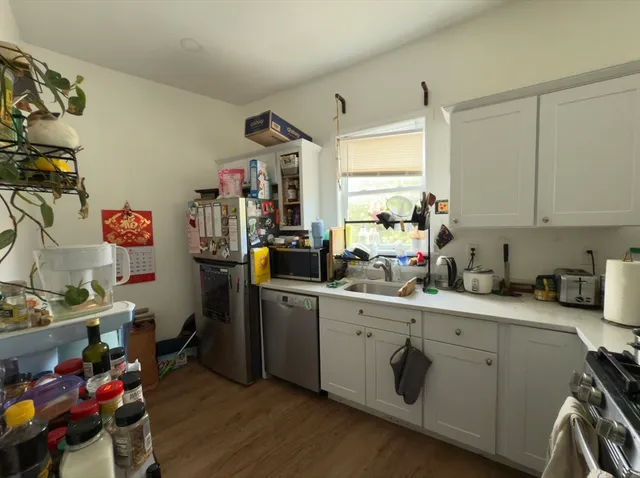 a kitchen with a sink stove and cabinets