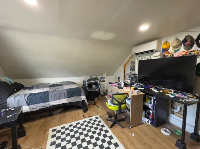 a bedroom with a bed and a flat screen tv