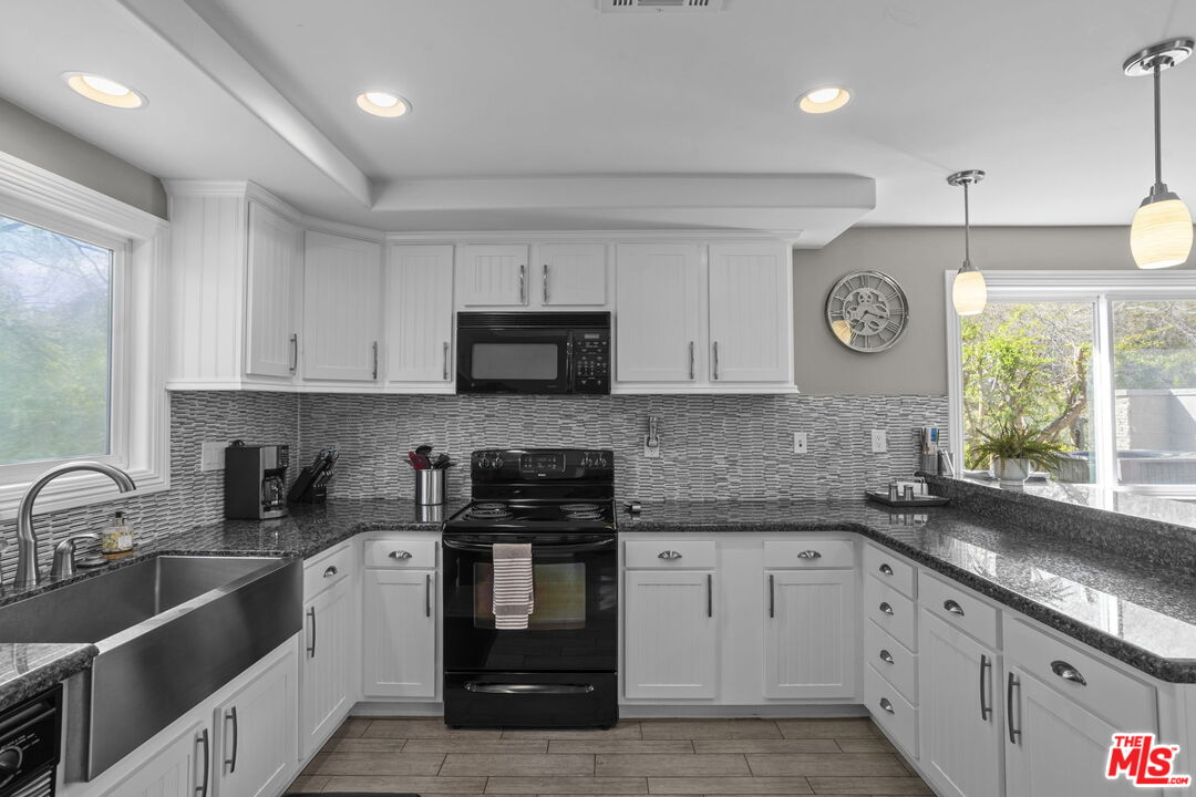 36880 East Benton Road Temecula, CA 92592 - Photo 15 of 75 a kitchen with stainless steel appliances granite countertop a sink stove and cabinets