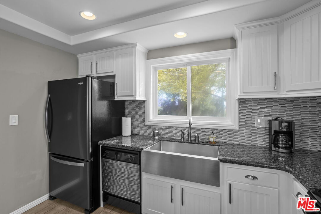 36880 East Benton Road Temecula, CA 92592 - Photo 16 of 75 a kitchen with granite countertop a refrigerator and a sink