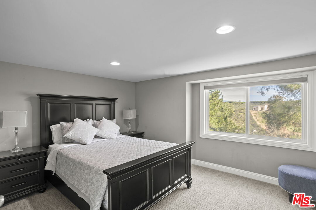 36880 East Benton Road Temecula, CA 92592 - Photo 17 of 75 a bedroom with a large bed and a window