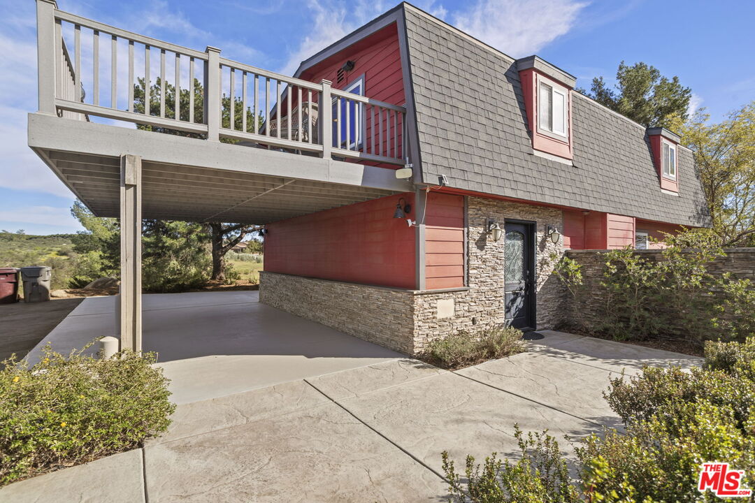 36880 East Benton Road Temecula, CA 92592 - Photo 2 of 75 a front view of a house with a yard and garage