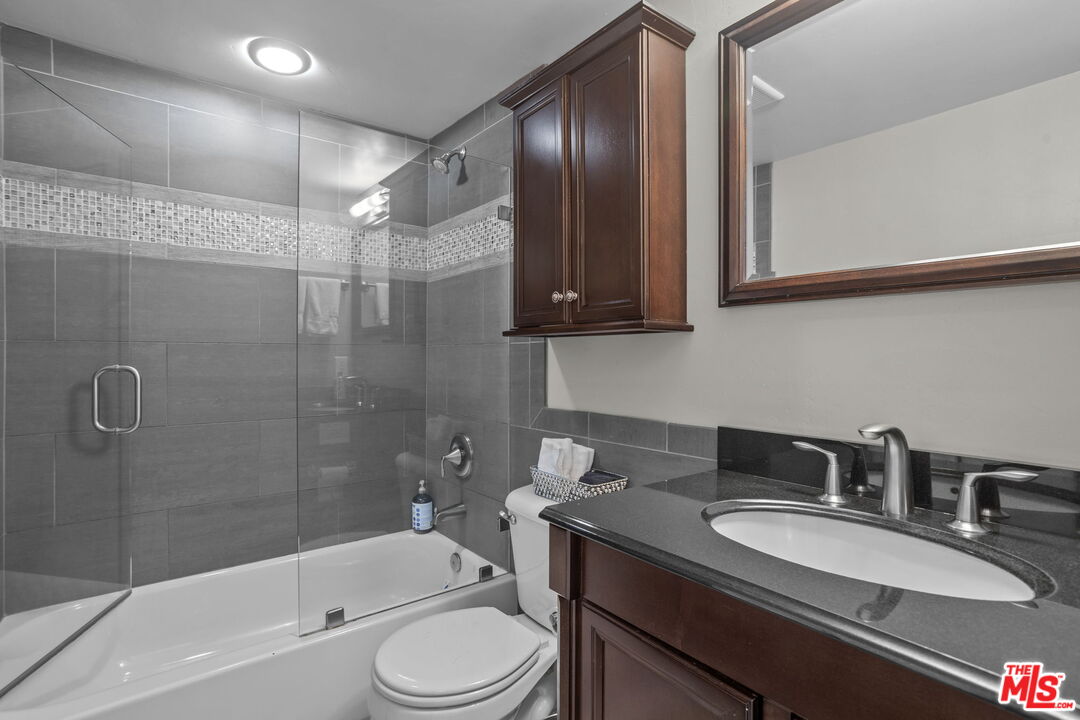 36880 East Benton Road Temecula, CA 92592 - Photo 28 of 75 a bathroom with a granite countertop sink toilet and shower