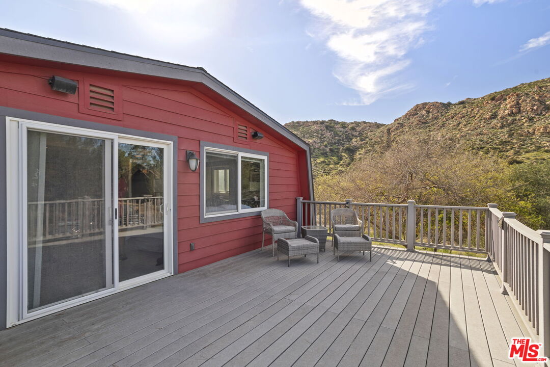 36880 East Benton Road Temecula, CA 92592 - Photo 32 of 75 a balcony with wooden floor table and chairs