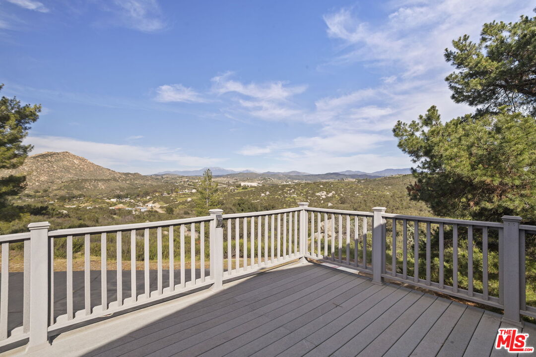 36880 East Benton Road Temecula, CA 92592 - Photo 33 of 75 a view of a balcony with wooden floor and fence