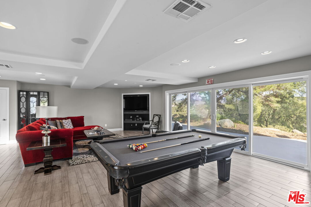 36880 East Benton Road Temecula, CA 92592 - Photo 8 of 75 a living room with furniture a flat screen tv and a large window