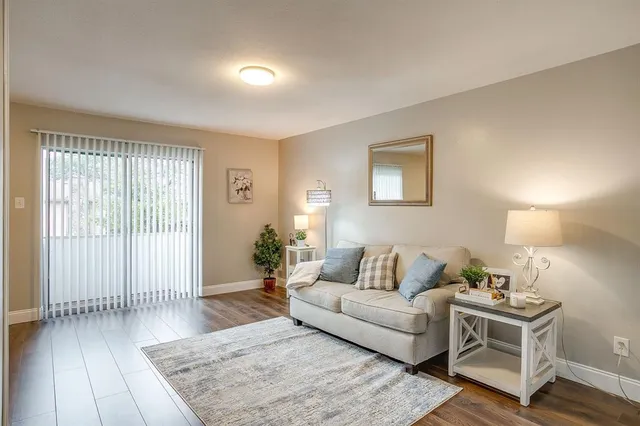 a living room with furniture and wooden floor