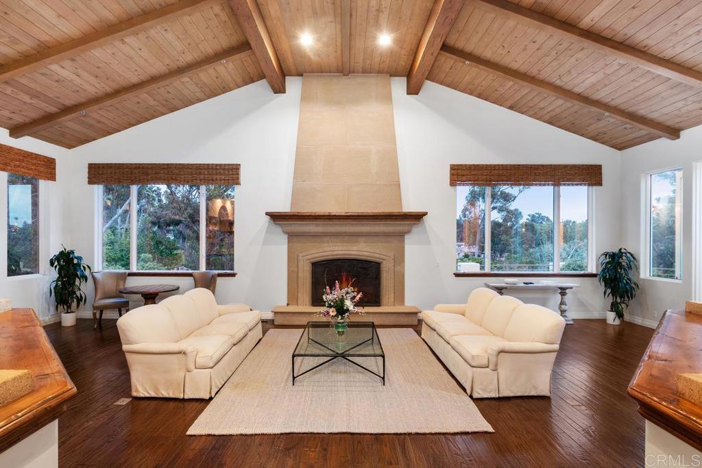 5315 La Crescenta Road Rancho Santa Fe, CA 92067 - Photo 2 of 17 a living room with furniture a large window and a fireplace