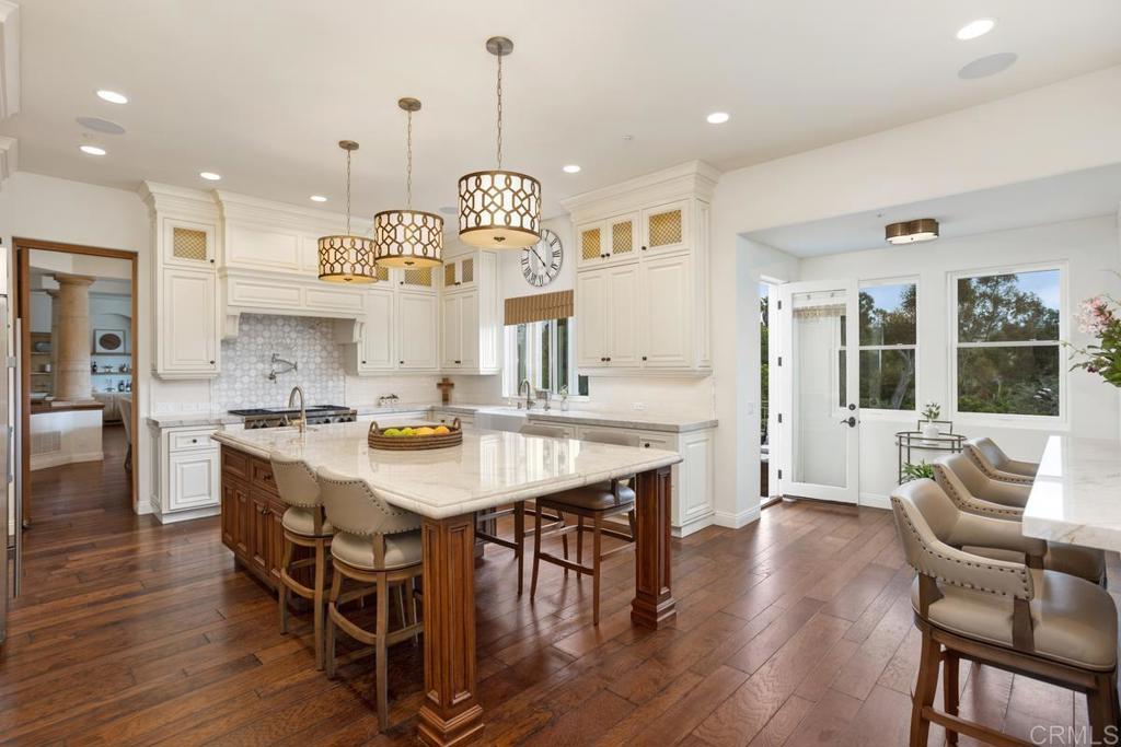 5315 La Crescenta Road Rancho Santa Fe, CA 92067 - Photo 5 of 17 a large kitchen with a table and chairs