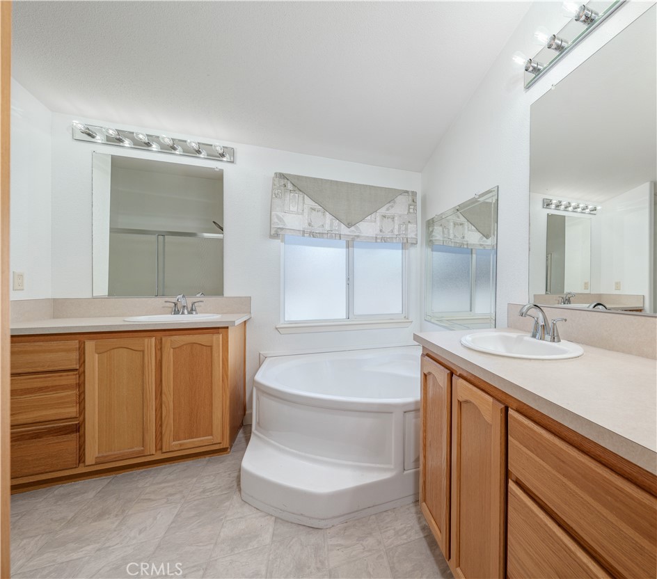 209 Rd Runner Lane Fountain Valley, CA 92708 - Photo 17 of 38 a bathroom with a sink and a mirror