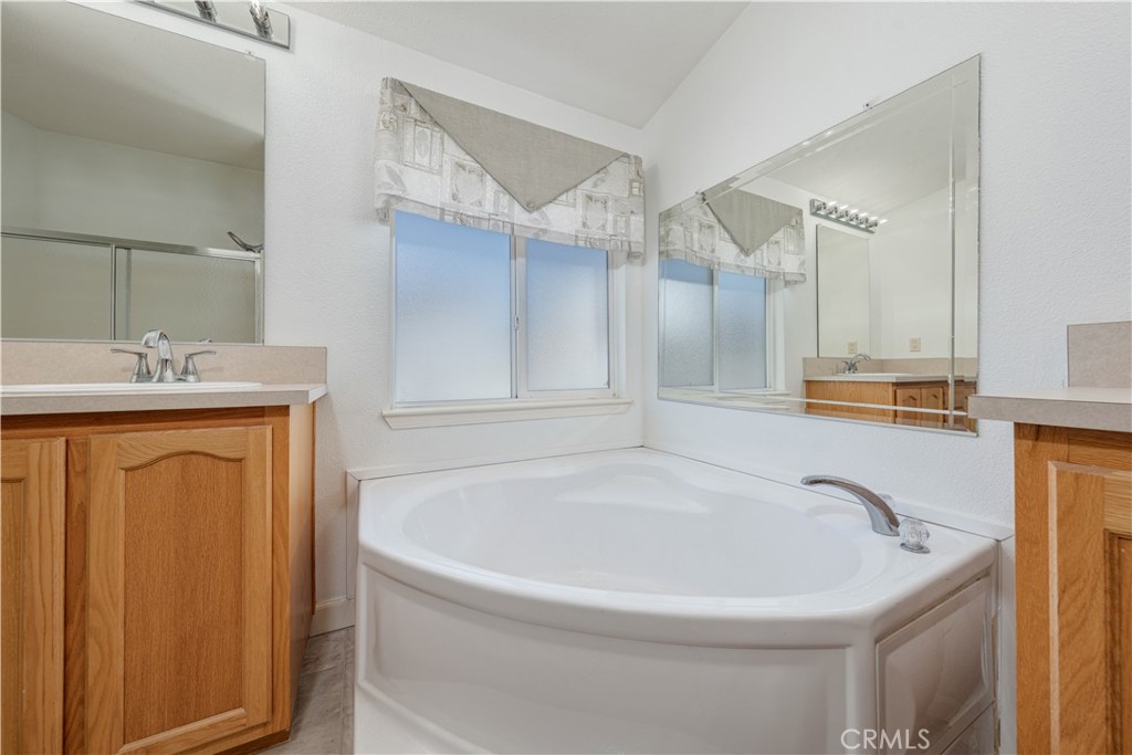 209 Rd Runner Lane Fountain Valley, CA 92708 - Photo 18 of 38 a white bath tub sitting next to a shower