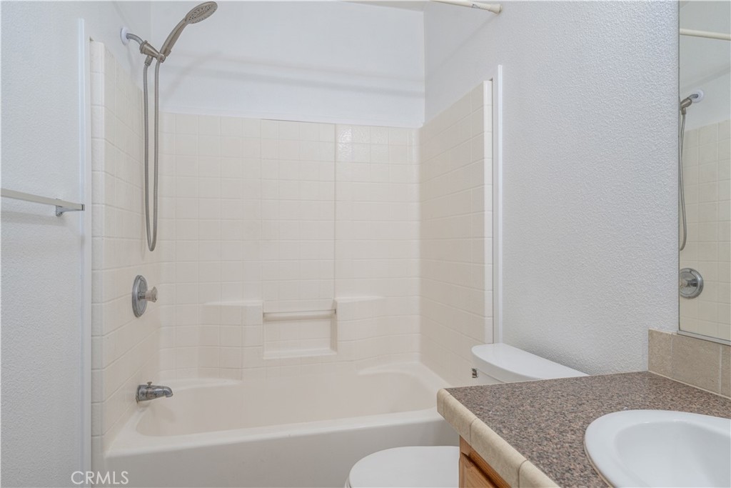 209 Rd Runner Lane Fountain Valley, CA 92708 - Photo 25 of 38 a bathroom with a granite countertop sink toilet and bathtub