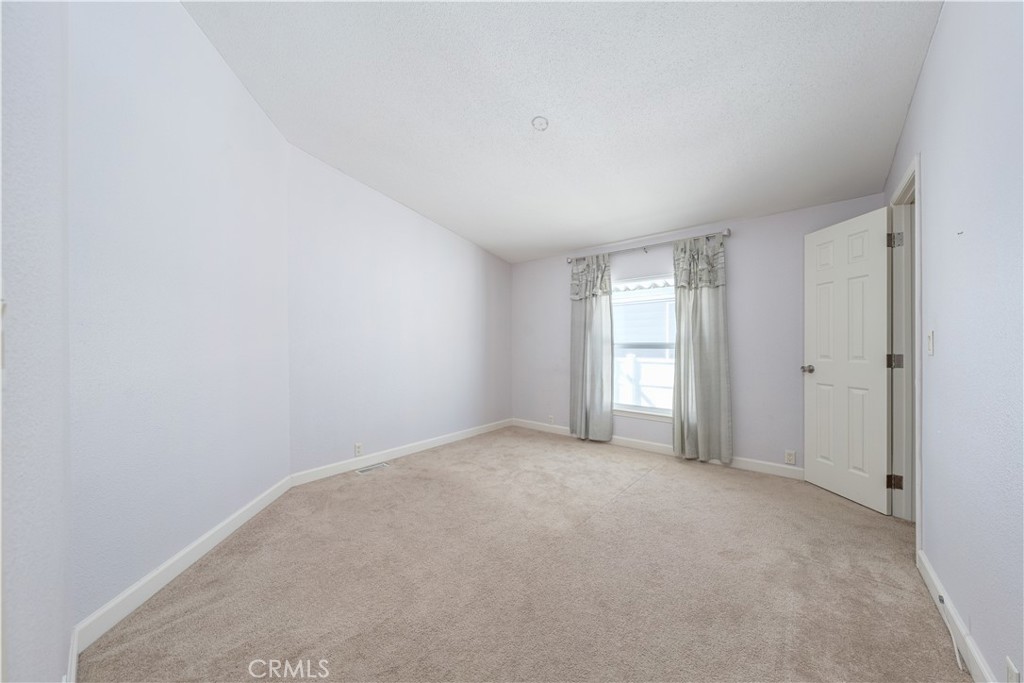 209 Rd Runner Lane Fountain Valley, CA 92708 - Photo 26 of 38 a view of an empty room with a window