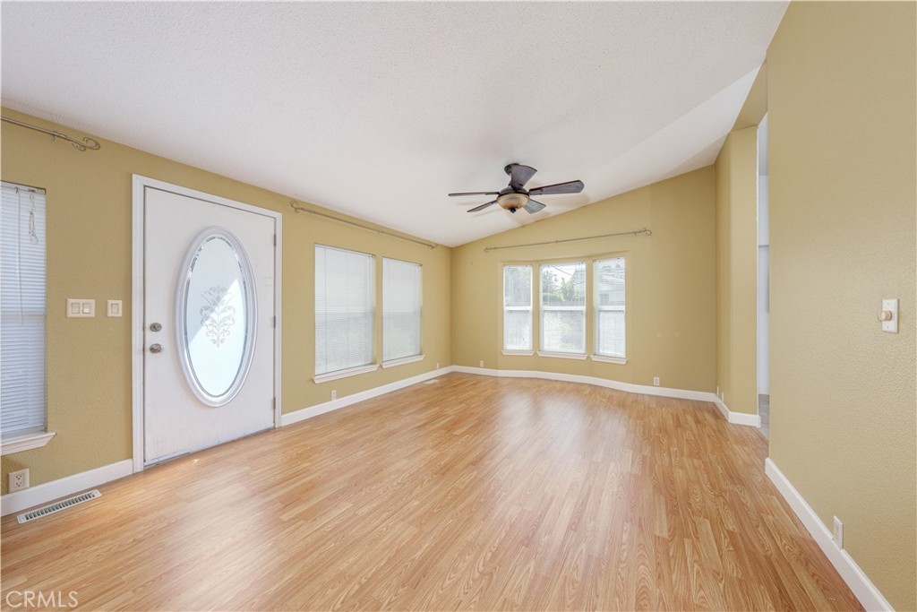 209 Rd Runner Lane Fountain Valley, CA 92708 - Photo 8 of 38 a view of empty room with wooden floor and fan
