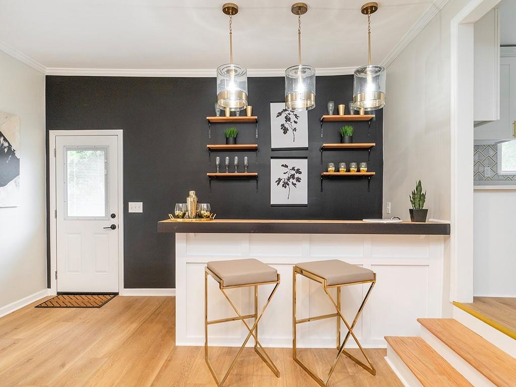 1720 Elder Way Burlington, NC 27215 - Photo 19 of 34 a view of kitchen island with wooden floor and cabinets
