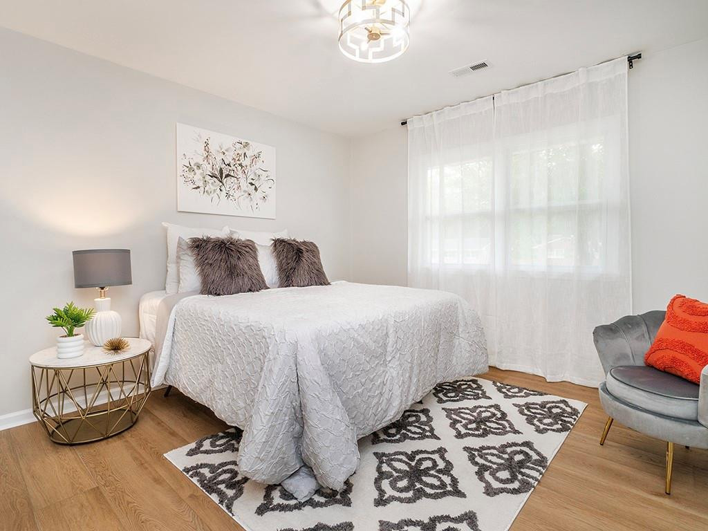 1720 Elder Way Burlington, NC 27215 - Photo 27 of 34 a bedroom with a bed and wooden floor