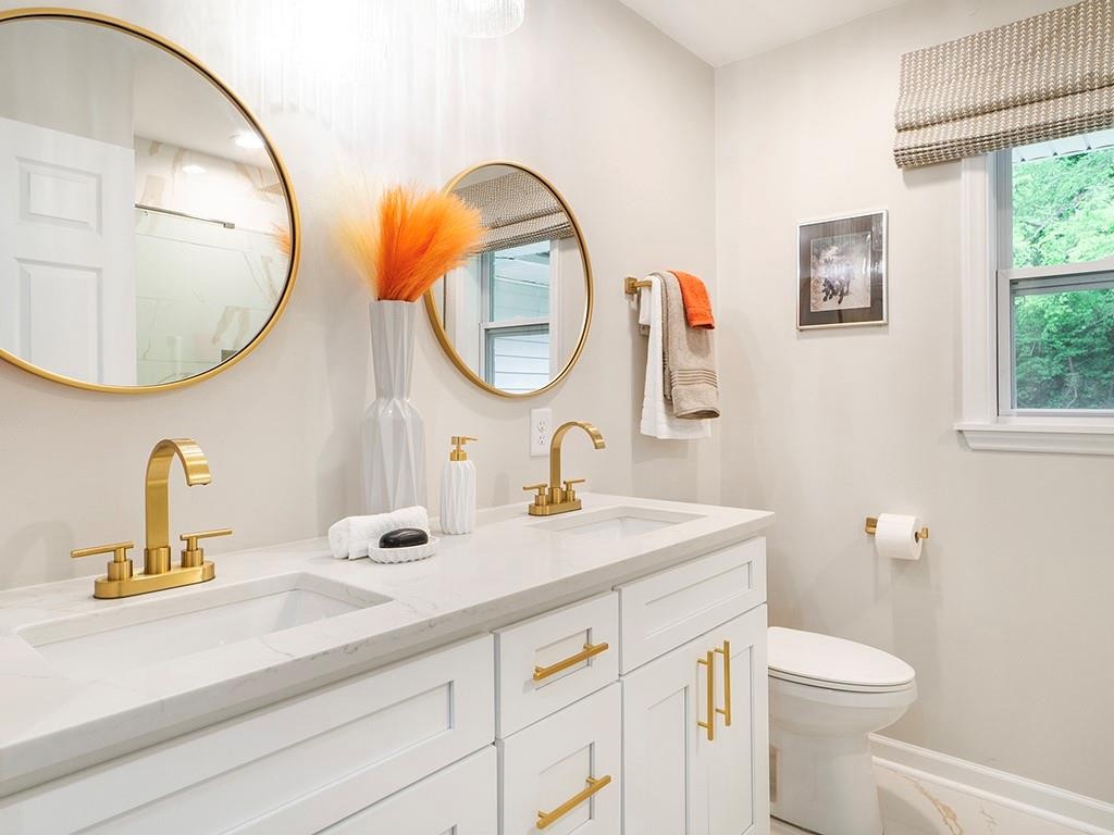 1720 Elder Way Burlington, NC 27215 - Photo 28 of 34 a bathroom with a sink a mirror a toilet and a sink