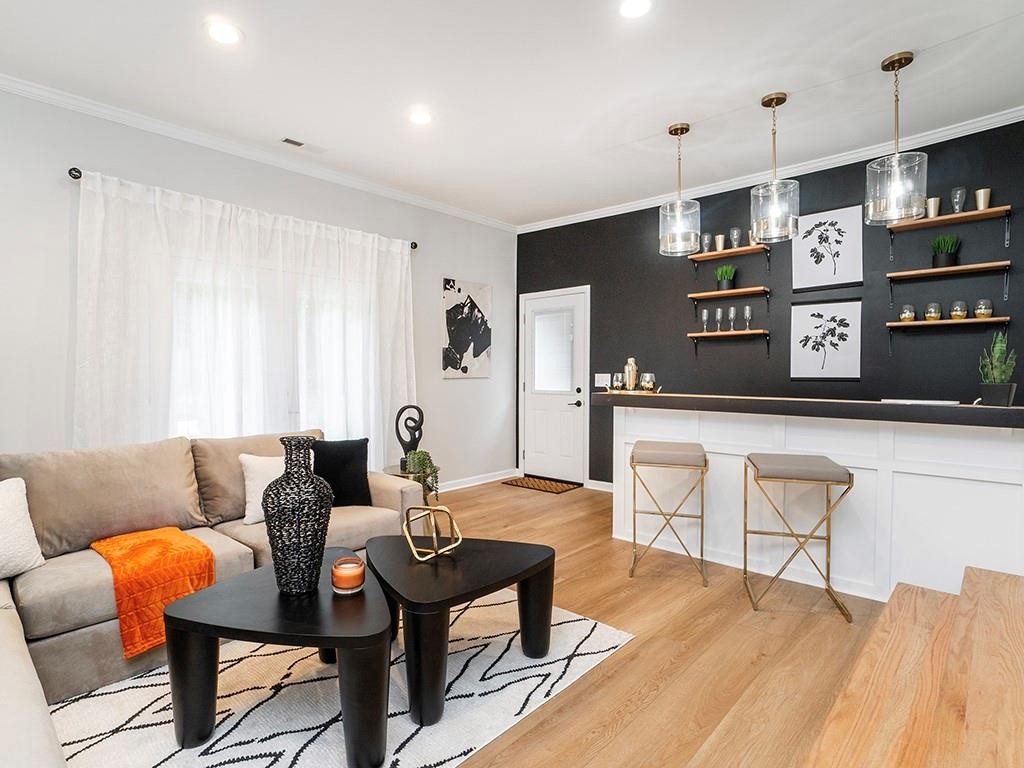 1720 Elder Way Burlington, NC 27215 - Photo 4 of 34 a living room with furniture a flat screen tv and a table