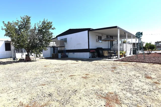 a view of a house with snow on the road