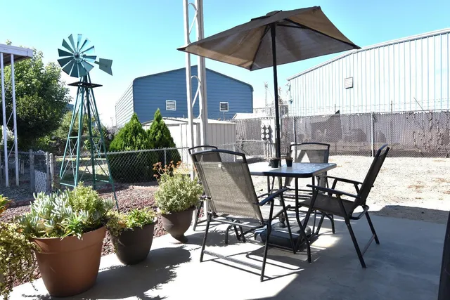 a view of a chair and table in the patio