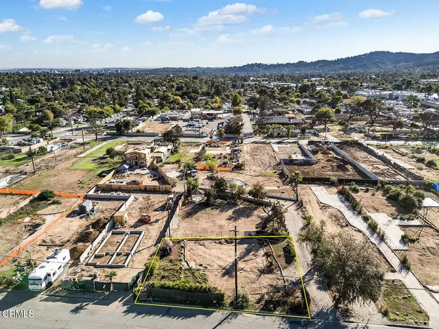 an aerial view of residential houses with city view