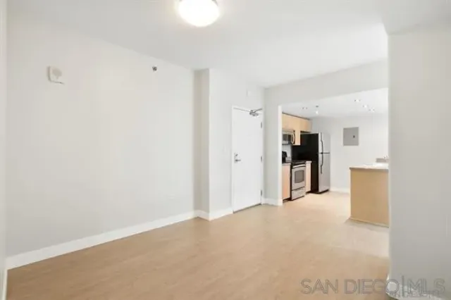 a view of a kitchen with refrigerator and a sink