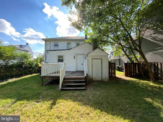 a view of a house with backyard and a tree