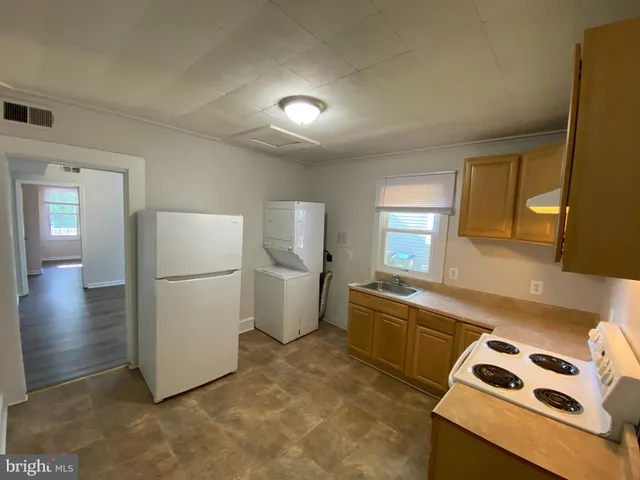a kitchen that has a refrigerator and a sink