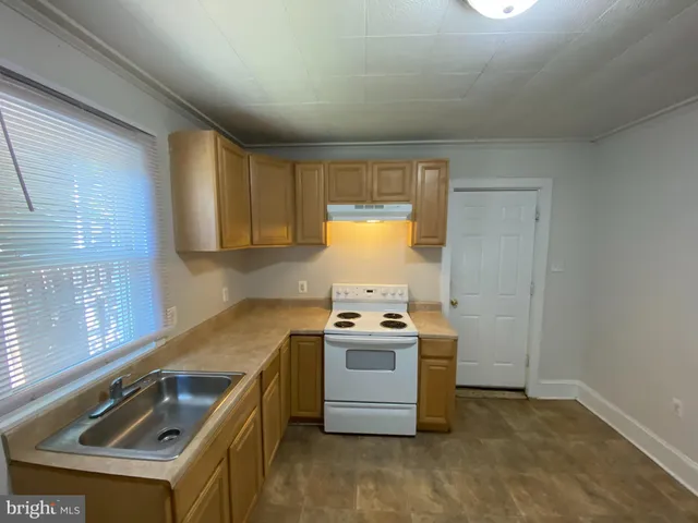 a kitchen that has a sink and a stove