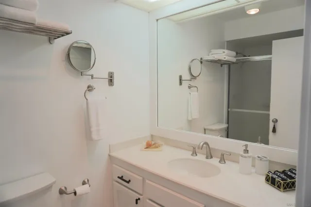 a bathroom with a sink vanity and a mirror