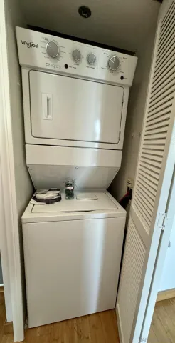 a close up of a washer dryer with wooden floor