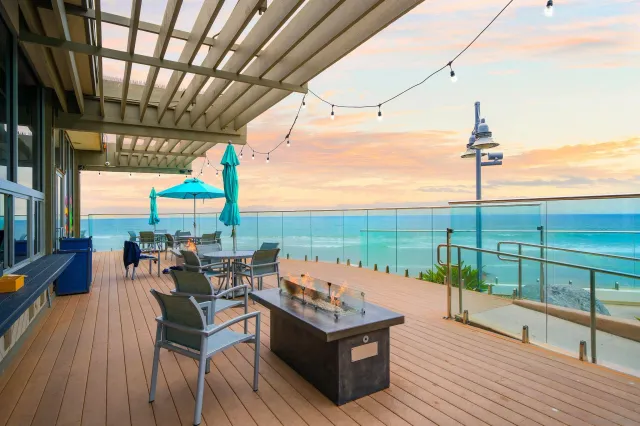 a roof deck with outdoor seating and city view