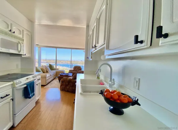 a kitchen with lots of white appliances and cabinets