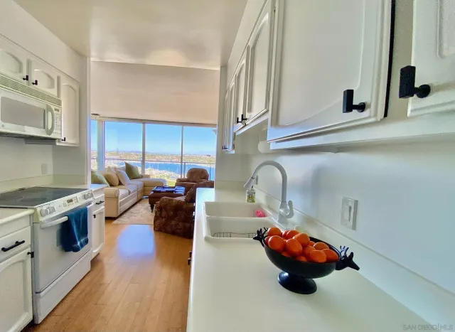 a kitchen with lots of white appliances and cabinets