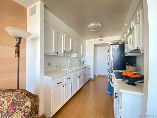 a kitchen with stainless steel appliances lots of counter top space and cabinets