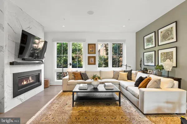 a living room with furniture a rug and white walls