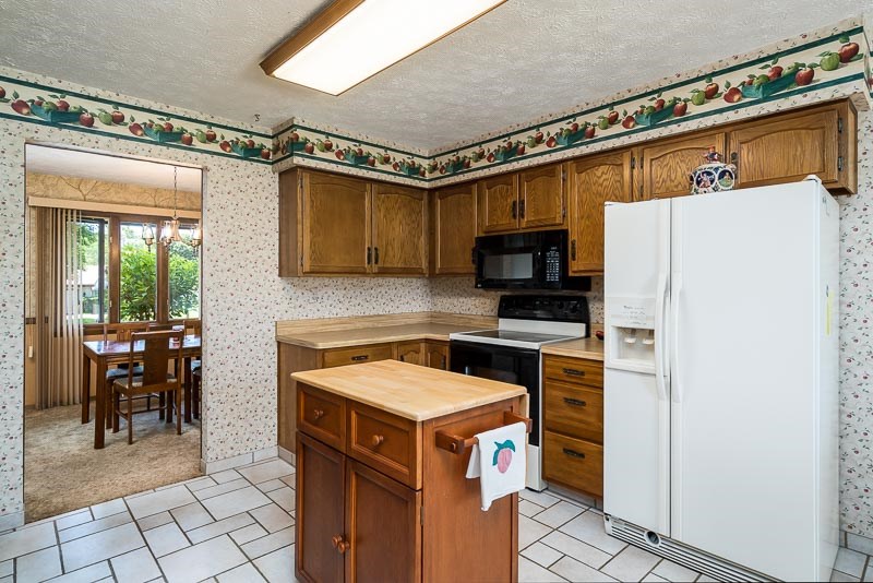 3644 Cutty Sark Road Cherry Valley, IL 61016 - Photo 12 of 33 a kitchen with a stove a refrigerator and a table