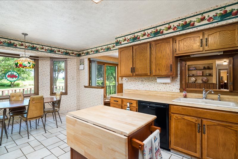 3644 Cutty Sark Road Cherry Valley, IL 61016 - Photo 13 of 33 a kitchen that has a sink a table and chairs in it