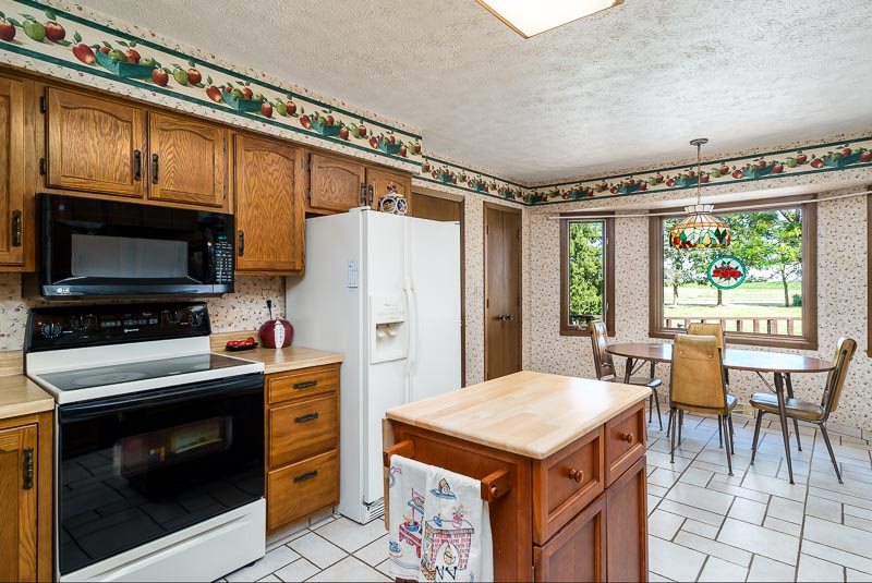 3644 Cutty Sark Road Cherry Valley, IL 61016 - Photo 14 of 33 a kitchen with a stove a refrigerator and a dining table