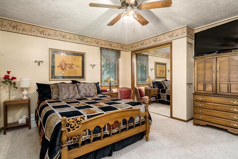 3644 Cutty Sark Road Cherry Valley, IL 61016 - Photo 16 of 33 a bed room with furniture and a flat screen tv