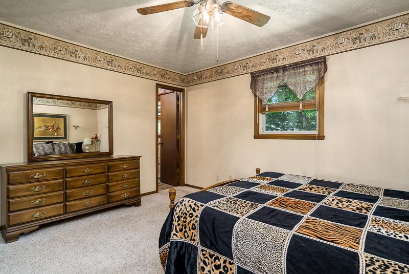 3644 Cutty Sark Road Cherry Valley, IL 61016 - Photo 18 of 33 a bedroom with a bed and a mirror on the dresser